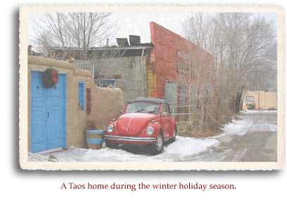 A Christmas wreath decorates the front of an adobe home in Taos, New Mexico.