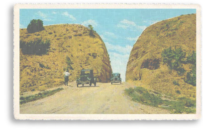  This vintage postcard features what was called as the “big cut” when the first road was built between Santa Fe and Albuquerque, New Mexico. Today, Highway 14is The model-T cars indicate that this (now-colorized) photo was taken during the 1920s. Today, Highway 14, also known as “The Turquoise Trail” is the “slow road,” with breathtaking scenery and outstanding rock formations, which connects the two cities.