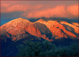 The iconic Taos Mountains in the sunset are truly "purple mountains majesty" in Northern New Mexico. New Mexico