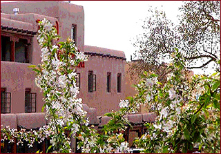 The historic Taos Plaza in spring. The Taos Plaza offers the visitor to New Mexico culture, history and art galleries. You can also enjoy great shopping and dining on the Plaza, the Bent Street historic district and more. 