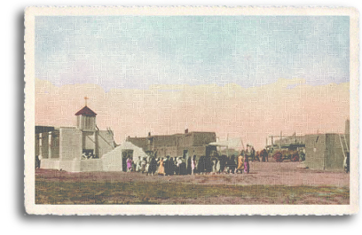 The vastness of the Northern New Mexico sky rises above the Taos Pueblo Church and the tribe members who have attended a service. A portion of the 1,000-year-old tiered pueblo dwellings are visible to the right.